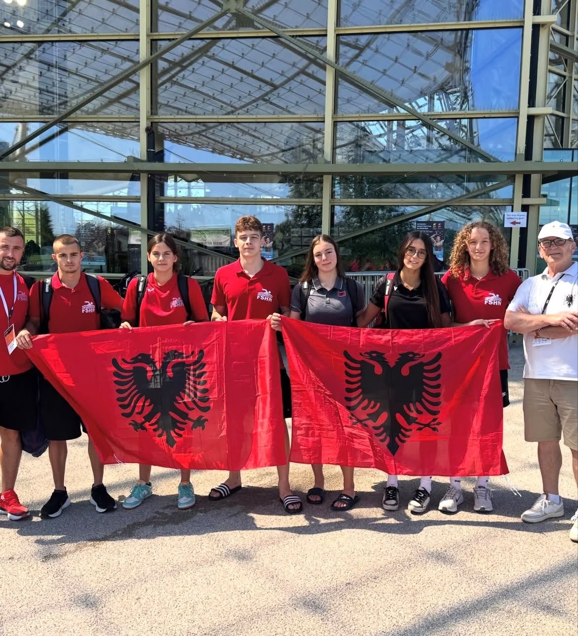 Albanian National Team swimmers holding national flags